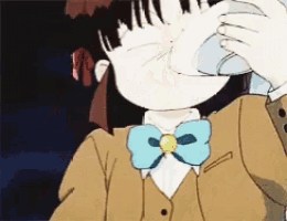 a girl wearing a bow tie and a brown jacket wipes her nose