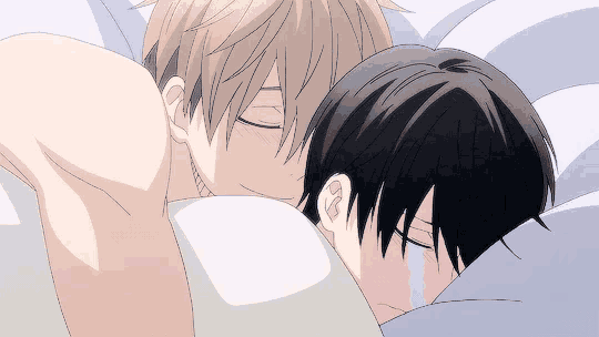 a couple of anime characters laying on a bed with one of them crying