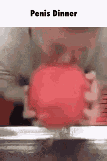 a man is eating a red apple with a fork and knife .