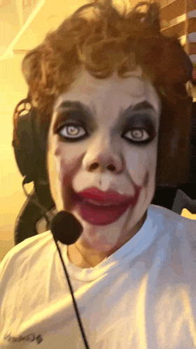 a woman is wearing a clown costume and a headset