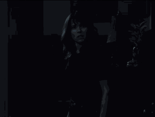 a dark room with a light coming out of the window