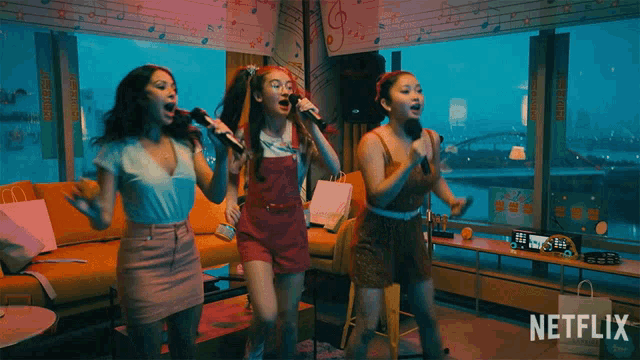 three girls singing into microphones with a netflix logo in the corner
