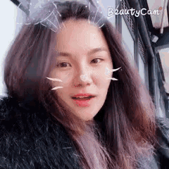 a close up of a woman 's face with a beauty cam filter on her face .