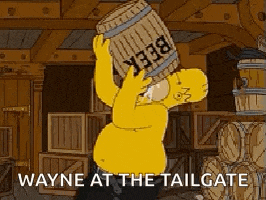 homer simpson is carrying a barrel of beer on his head and says wayne at the tailgate .
