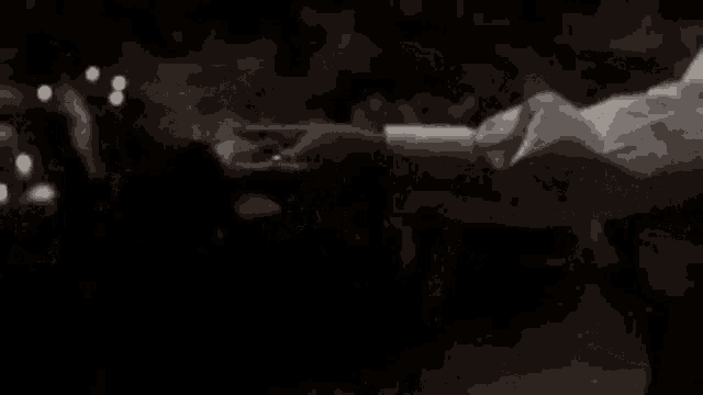 a black and white photo of a man and woman holding hands .