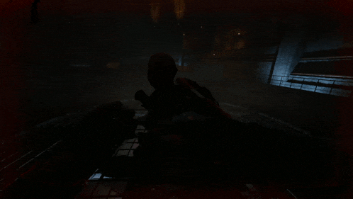 a man in a dark room with a gun in his hand