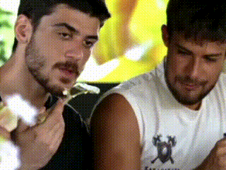 two men are eating food together and one of them is wearing a shirt with a horse on it
