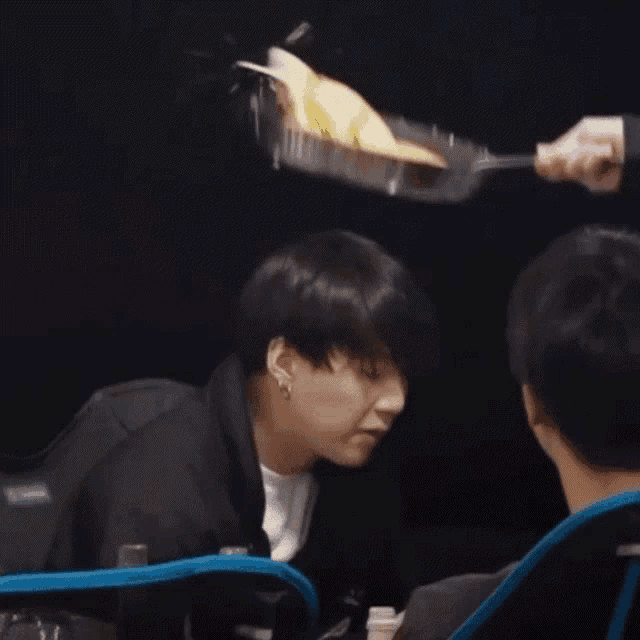 a person is holding a frying pan with a piece of food on it
