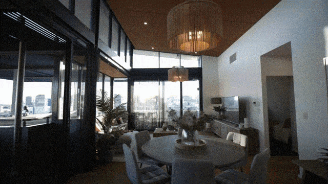 a living room with a dining table and chairs
