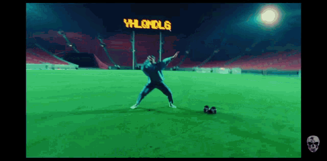 a man is dancing on a soccer field in front of a sign that says vhlandle