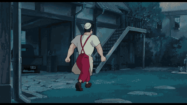 a man in a white shirt and red pants is walking in front of a building with a license plate that says cg