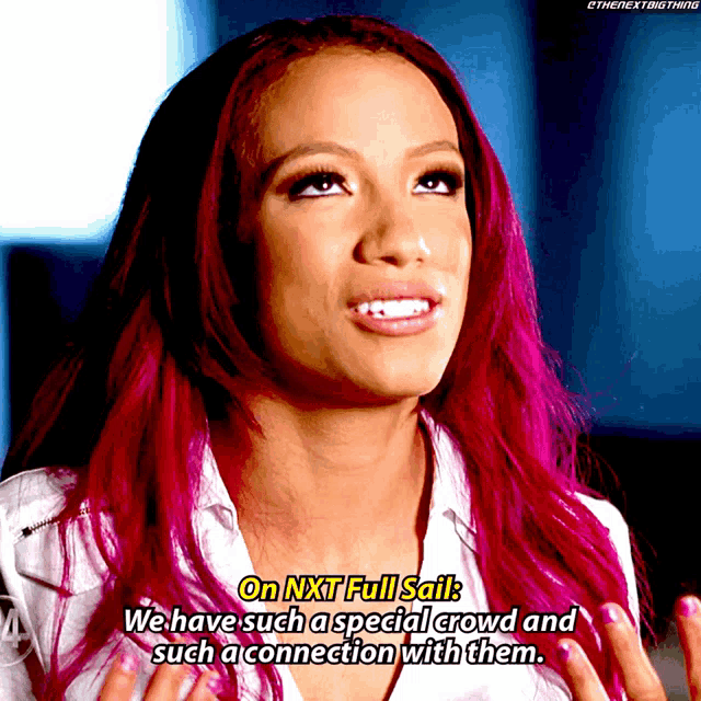 a woman with pink hair is talking about nxt full sail