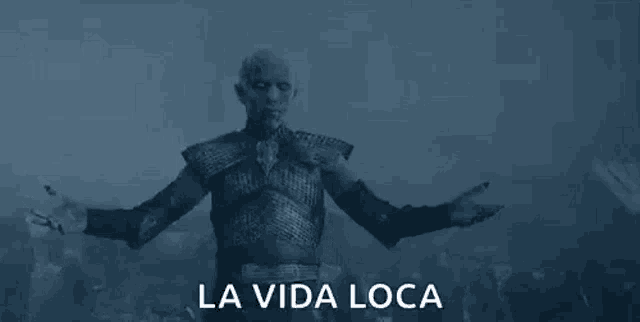 a man is standing in front of a crowd of people with his arms outstretched in a game of thrones scene .