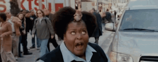 a woman with a rat on her head stands in front of a crowd of people