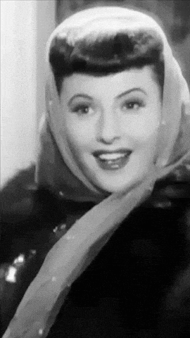 a black and white photo of a woman wearing a scarf on her head