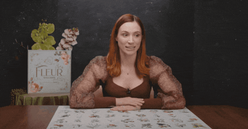 a woman sitting at a table with the words " no-one is complaining " above her