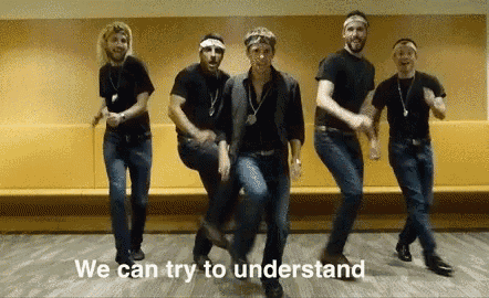 a group of men are dancing in a room with the words we can try to understand above them