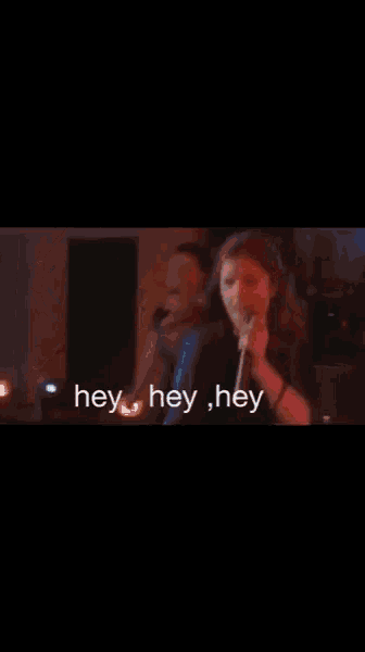 a group of people are dancing on a stage and the words hey hey hey are on the bottom