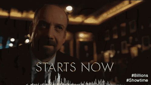 a man in a suit and tie with the words starts now behind him