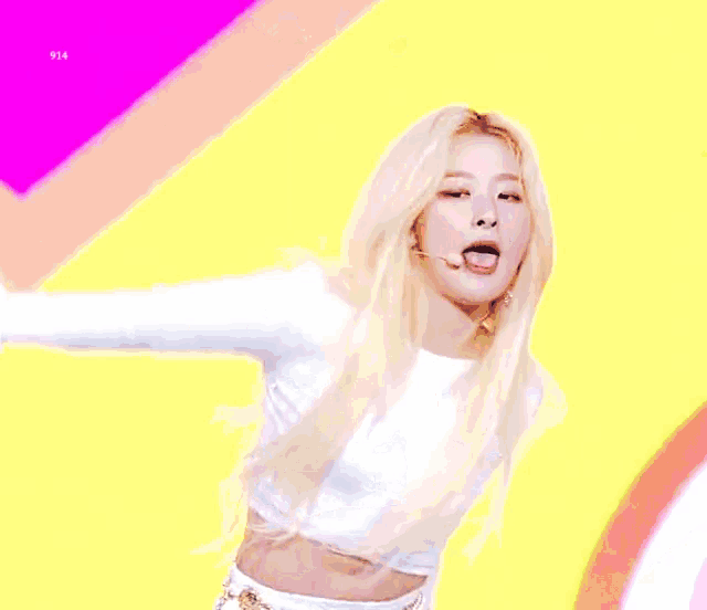 a woman with blonde hair is wearing a white top and white shorts
