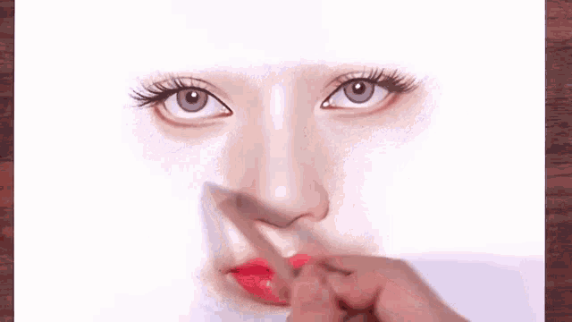 a person is drawing a woman 's face with a pencil and red lipstick .