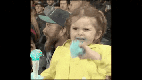 a little girl with cotton candy on her face