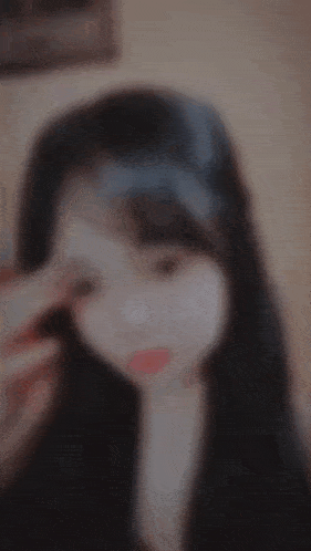 a blurry photo of a girl with long hair