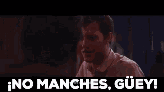 a group of men sitting at a table with the words no manches guiey written in white