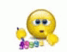 a pink and purple easter egg with a face on it is sitting next to a bunch of lego bricks .