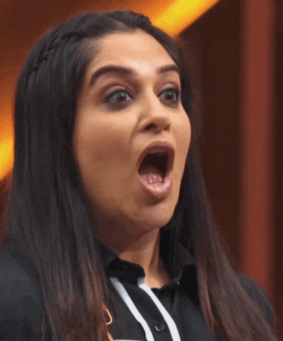 a woman with her mouth wide open making a funny face