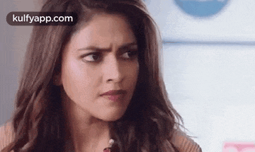 a close up of a woman making a funny face with her eyes closed .