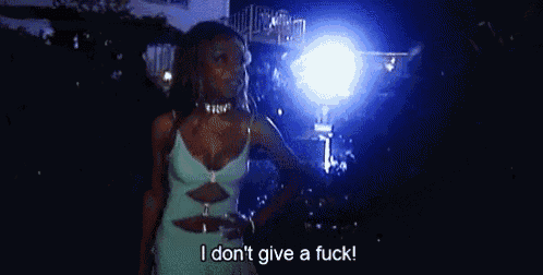 a woman in a blue dress is standing in front of a pool at night and says `` i don 't give a fuck ''