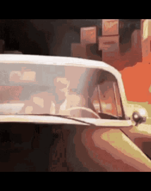 a man is driving a car with boxes behind him