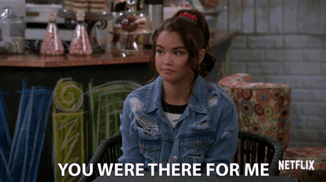 a girl in a denim jacket is sitting at a table and says " you were there for me "