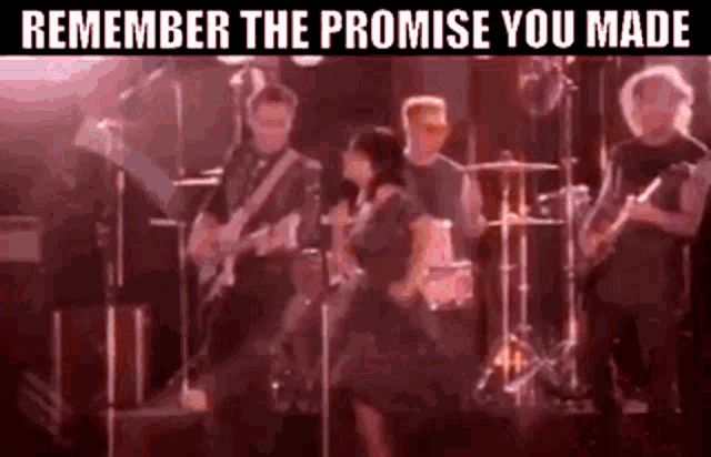 a group of people are playing instruments on a stage and singing .