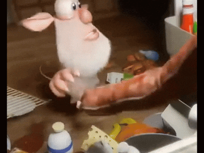 a cartoon character with a beard is holding a sausage on a table .