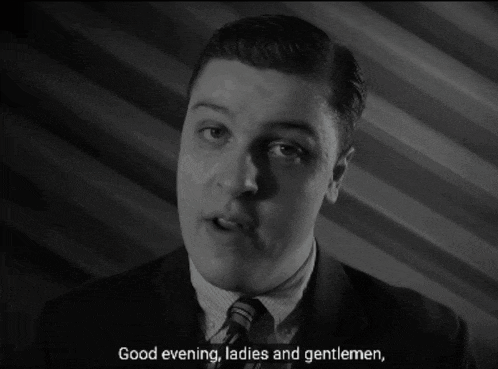 a man in a suit and tie is saying " good evening ladies and gentlemen "