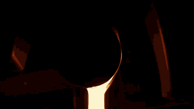 a candle is burning in a dark room