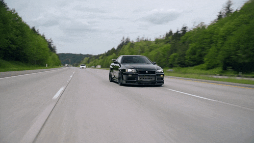 a black car with a license plate that says nismo