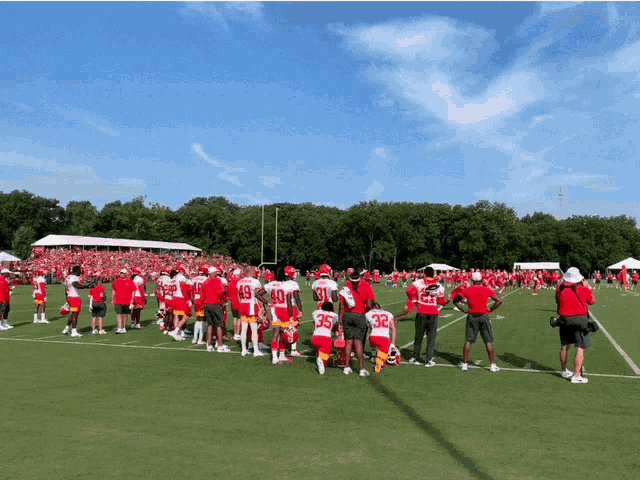 a group of football players are gathered on a field and one of them is wearing number 35
