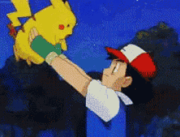 a man in a red white and blue hat is holding a pikachu