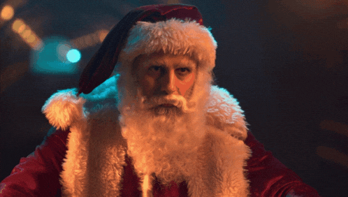 a man dressed as santa claus with a beard and hat