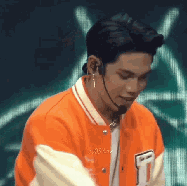 a close up of a person wearing a microphone and earphones .
