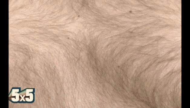 a close up of a person 's face with the number 5x5 visible