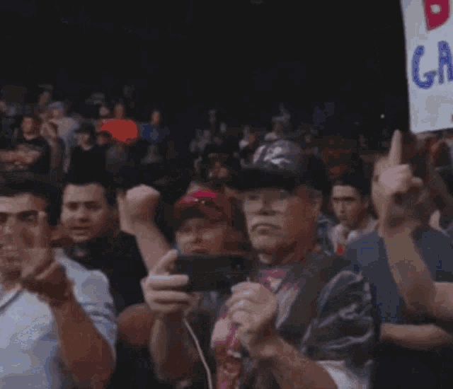 a crowd of people holding up signs including one that says ' dri gall 1 '