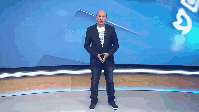 a man in a suit stands in front of a blue background that says ' a2 ' on it