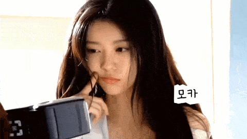 a woman is looking at a clock with the time of 3:33