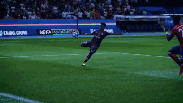 a soccer player wearing a fly emirates jersey is kicking a ball