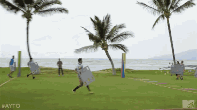 a group of people running on a field with a mtv logo on the bottom