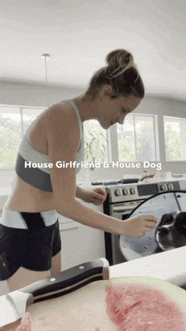 a woman is cutting a watermelon in a kitchen with the words house girlfriend and house dog on the bottom